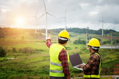 Two engineering work with together at the windmill farm